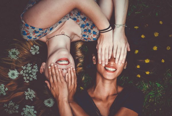 Two Girls Covering Each Others Eyes